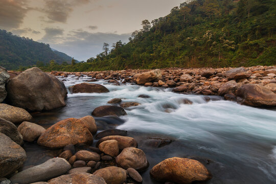Scenic beauty of Jaldhaka River and stones at river bed, flowing through India, Bhutan, and Bangladesh. Originating from Kupup Lake in East Sikkim. At Jhalong-Dooars, north bengal- West Bengal, India.