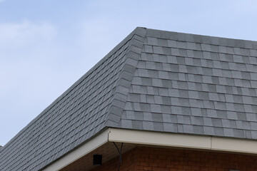 Fototapeta premium Close-up view of gray asphalt shingles on residential roof