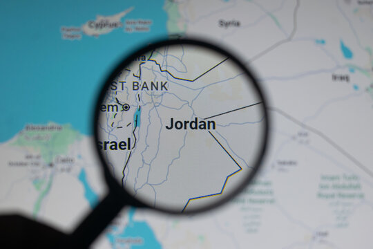 Magnifying glass highlights Jordan on a Middle East map amid Iran war tensions involving Israel and USA, showing regional conflict, borders, security risks, geopolitical instability and crisis concern