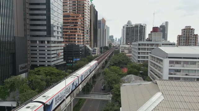 Skytrain Moves Down The Line Into Ari BTS Station In Bangkok Thailand Cloudy Day 4K 60FPS