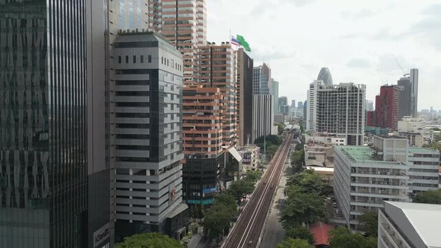 Ari Neighborhood Cloudy Day Downtown Bangkok Thailand Drone Rise Above Skytrain Line 4K 60FPS