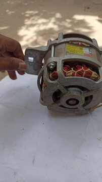 Technician Performing Maintenance on Washing Machine Electric Motor