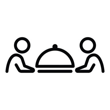 Two people sitting at a table with a covered dish in front of them icon