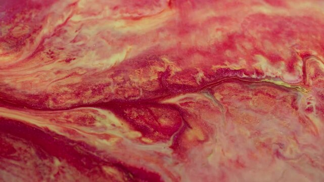 Ink wave. Color blend. Defocused red yellow glitter texture spatter flow liquid floating on abstract acrylic creative art background.