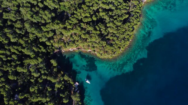 Aerial top down view of paklina cove and a sailboat in hvar, croatia