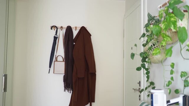 Coat and umbrella hanging in an entryway
