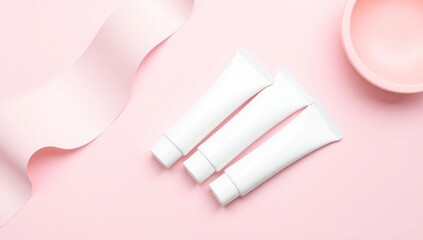 Naklejka premium Aesthetic pink background with three white tubes and a pink ribbon