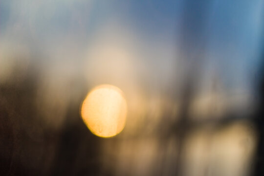 Blurry golden sunset background with warm bokeh light.