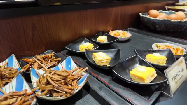 Japanese Buffet Selection with Tamagoyaki Omelet and Side Dishes