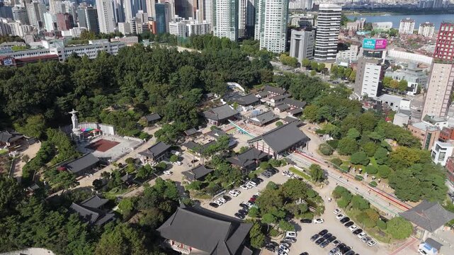 Aerial Drone Flight Approaching Bongeunsa Temple Surrounded by Modern Gangnam Skyline in Seoul South Korea