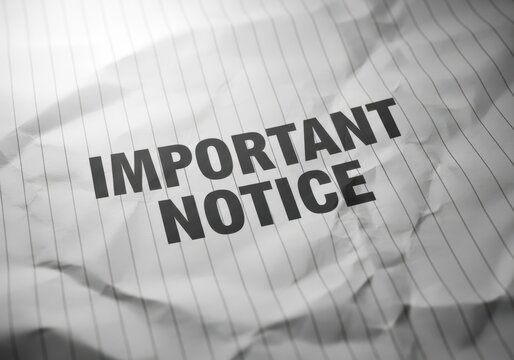 Important notice text on crumpled lined paper