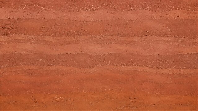 Layered red clay soil texture showing horizontal sediment bands