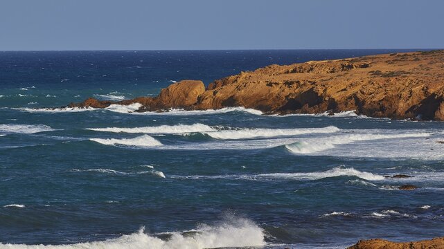 Rippled sea surface along a rocky coastline under a clear sky, west coast, Karpathos, Dodecanese, Greek Islands, Greece