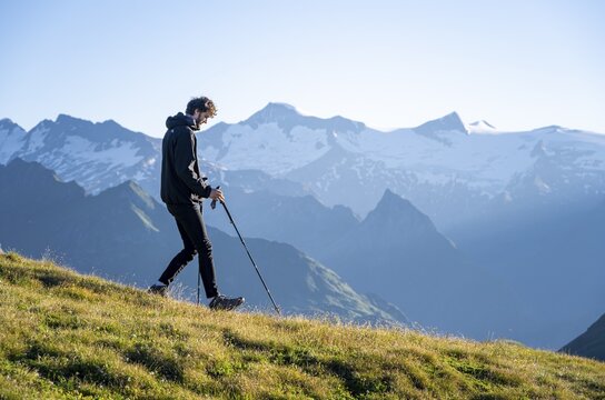 Hiker enjoying the mountain panorama in the morning, Venediger group, behind Dreiherrenkopf, Simonysitze and Gro&szlig;er Geiger, Hohen Tauern, Austria