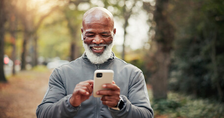 Fototapeta premium Fitness, earphones and man with phone, laughing and watching funny exercise tutorial on social media. Happy, mature runner and black person with mobile on workout break, online and streaming music