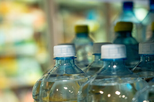 A Close-Up View of Water Bottles in a Refrigerated Display, Highlighting Their Clear Design and Cap Features in an Organized Arrangement.