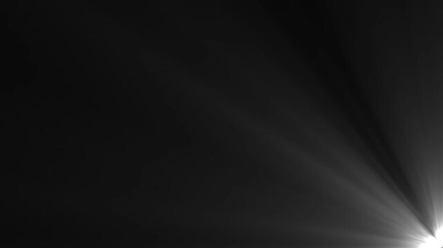 White dramatic light rays streaming upward from bottom right corner on black background overlay.