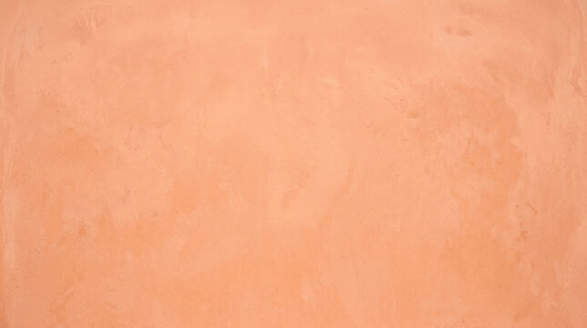 Soft peach salmon plaster wall texture background for warm minimal design