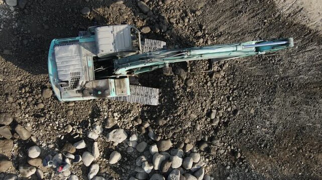 Aerial Scenery of Excavator Operating in Rock Quarry Mine with Gravel and Boulder Extraction, Construction and mining site view from above 