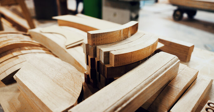 Woodworking, workshop and timber stack on table, manufacturing and material for furniture production. Carpentry, process and custom lumber for architectural project, restoration and craftsmanship