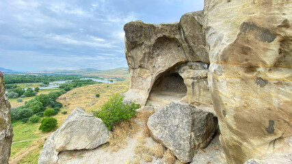 Uplistsikhe cave opening overlooks the Kura River valley from a rocky hillside in Georgia, presenting ancient settlement planning © chekart