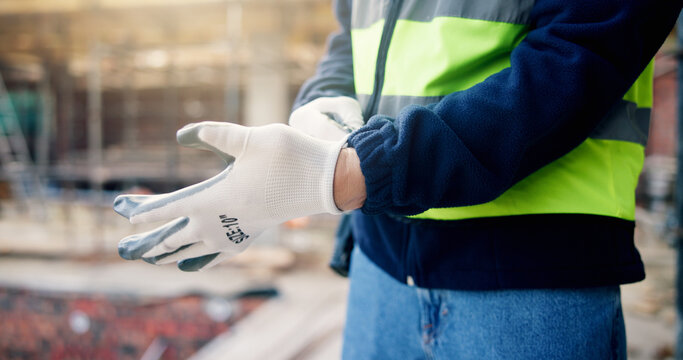 Hands, gloves and worker on construction site for job, architecture and PPE with preparing for renovation. Person, protective gear and ready for remodeling project, compliance and safety for labor
