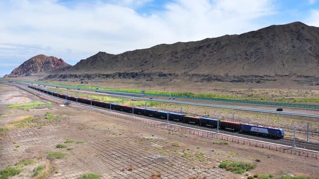 Aerial view of freight train at Alashankou Port along the Silk Road in Xinjiang
China-Europe cargo railway running through arid mountain border area
Belt and Road international trade transport