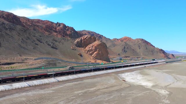 Aerial view of freight train at Alashankou Port along the Silk Road in Xinjiang
China-Europe cargo railway running through arid mountain border area
Belt and Road international trade transport