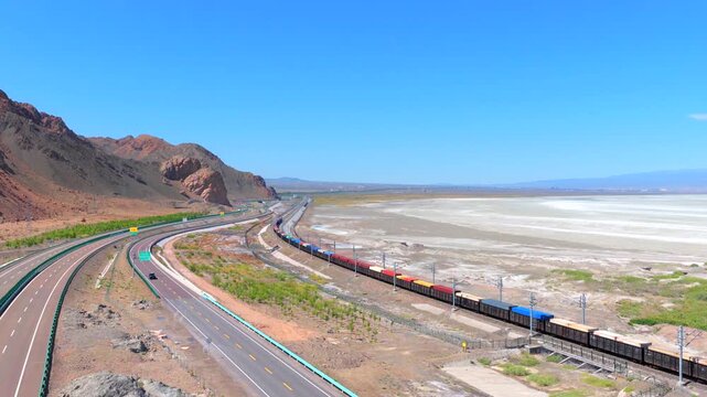 Aerial view of freight train at Alashankou Port along the Silk Road in Xinjiang
China-Europe cargo railway running through arid mountain border area
Belt and Road international trade transport