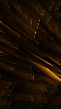 Golden light streaks rush through a dark cinematic tunnel with dramatic motion blur and radiant reflections creating a luxurious high energy showcase background for premium events and showtime intros