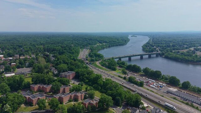 Distant aerial fly to Julia B. Buxton Bridge transportation hub connecting with 91 Highway on beautiful landscape, Springfield, Massachusetts, US