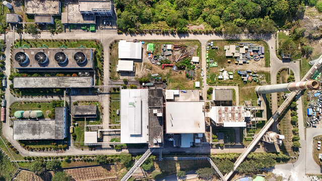 Modern power plant complex in a rural setting, representing utility services, heavy industry and economic resilience.