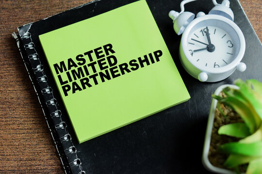 Concept of master limited partnership write on sticky notes isolated on Wooden Table.