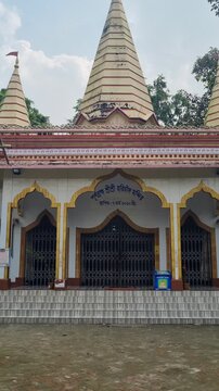 Vertical shot of Purnobromh Shri Shri Harichand Thakur Temple in Dhaka, Bangladesh, showcasing its distinctive shikhara towers, traditional Hindu architecture, and spiritual significance for the Matua
