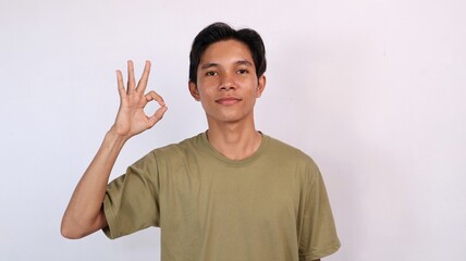 Naklejka premium handsome asian young man showing okay gesture
