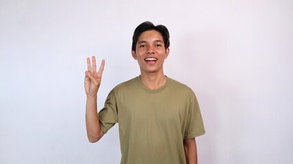 Naklejka premium Asian young man showing number three gesture
