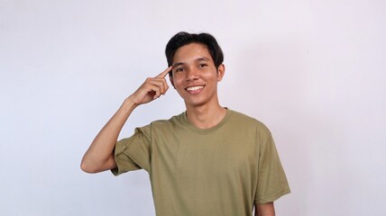 Fototapeta premium Asian young man gesturing thinking smart and careful smiling expression