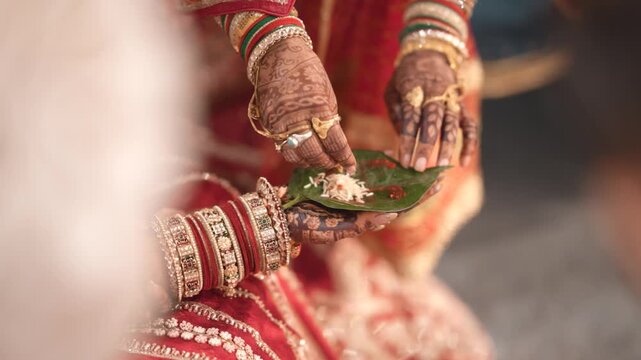 Close up of bridal chooda hands in traditional Hindu wedding ceremony