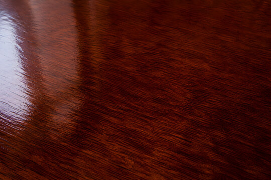 Glossy red lacquered wood texture close up