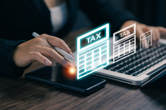 Businesswoman using a tablet and laptop with digital tax calculator interface, illustrating online tax management, financial planning, accounting, business reporting, and electronic filing.