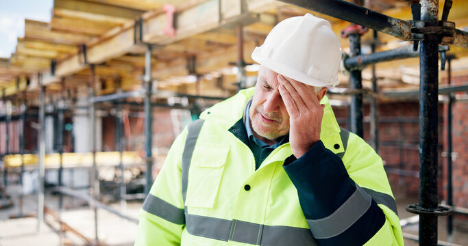 Headache, man and construction worker on site with fatigue, burnout or mistake on infrastructure. Migraine, tired and mature civil engineer with error on building renovation, repairs or maintenance.