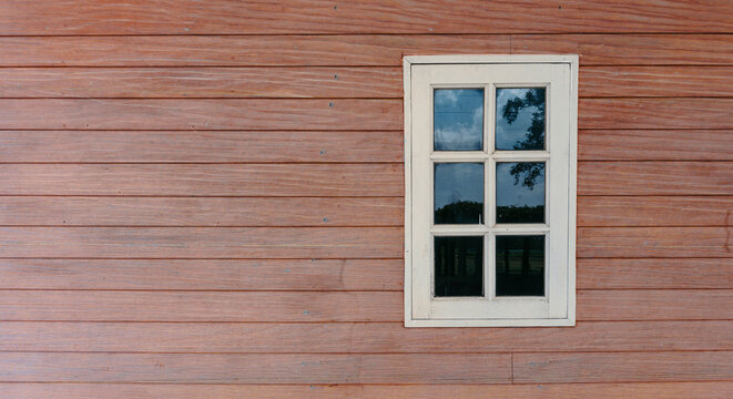 white window on red brown wood wall panel , rustic old grunge wooden texture,  nostalgia decoration background for rural barn cabin hunt bungalow  
