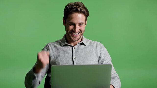 Young Cryptocurrency Trader Emotional Reaction on Green Screen Background Showing Success and Happiness While Using Laptop