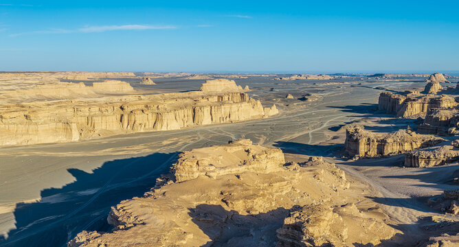 Aerial view of vast yardang landforms with dry riverbeds and clay canyons in Dahaidao, Gobi Desert, Xinjiang, China