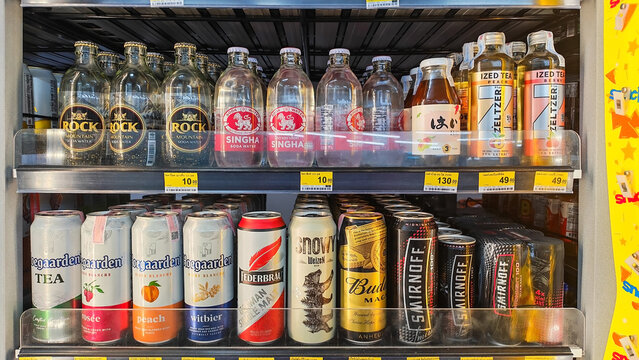 Assorted Beverages in Refrigerator Display. Assorted Canned and Bottled Alcoholic Beverages and Soda Water Displayed on Supermarket Refrigerator Shelf. Thailand, July 21, 2026