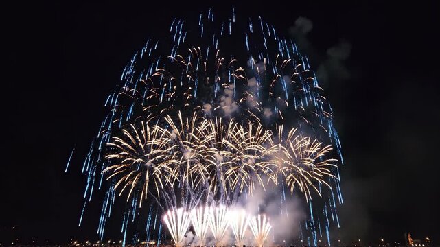 Blue firework explosion over city skyline at night