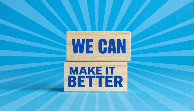 Two Wooden Blocks Displaying We Can Make It Better Text Stacked Against a Blue Radial Sunburst Background