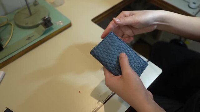 Scissors cut scalloped edge pattern into teal leather panel