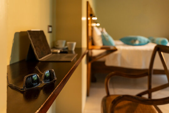 Sunglasses on hotel room desk offering relaxation and work