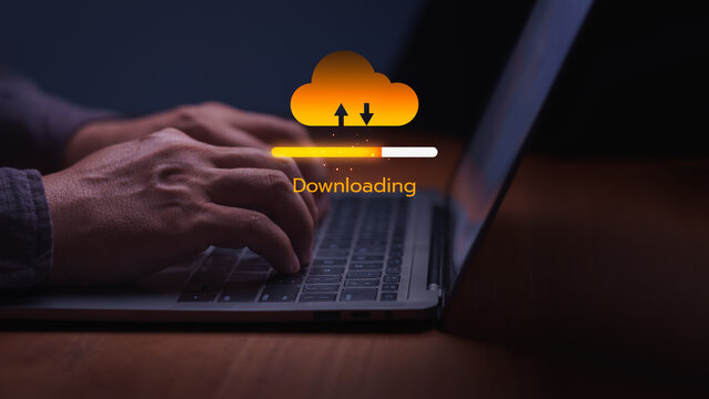 Man typing on a laptop with a glowing digital progress bar downloading data from a cloud computing network. This technology connection provides fast internet storage transfer.